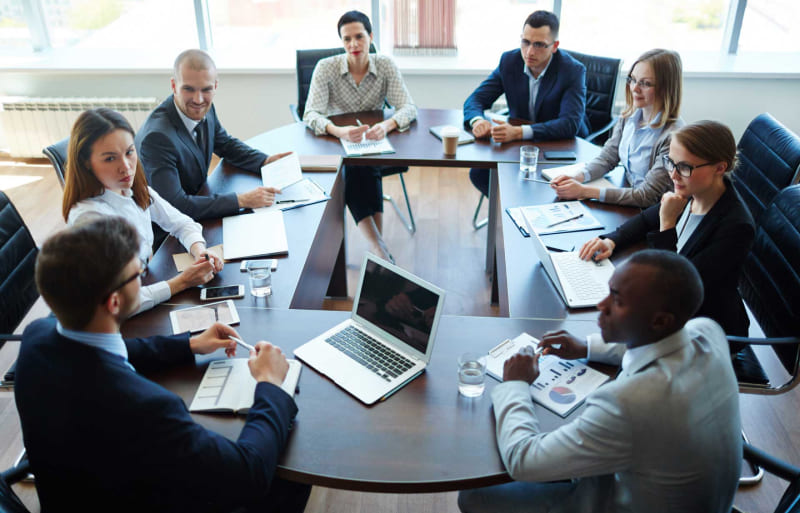 People gathered around a conference desk