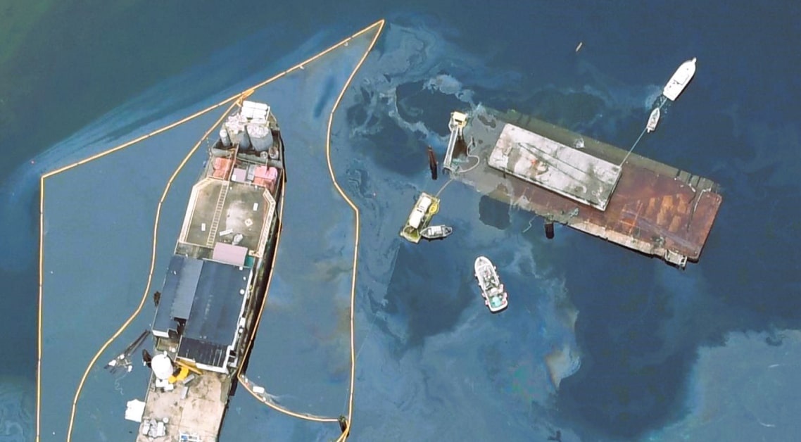 Overhead shot of a ship with oil spill.