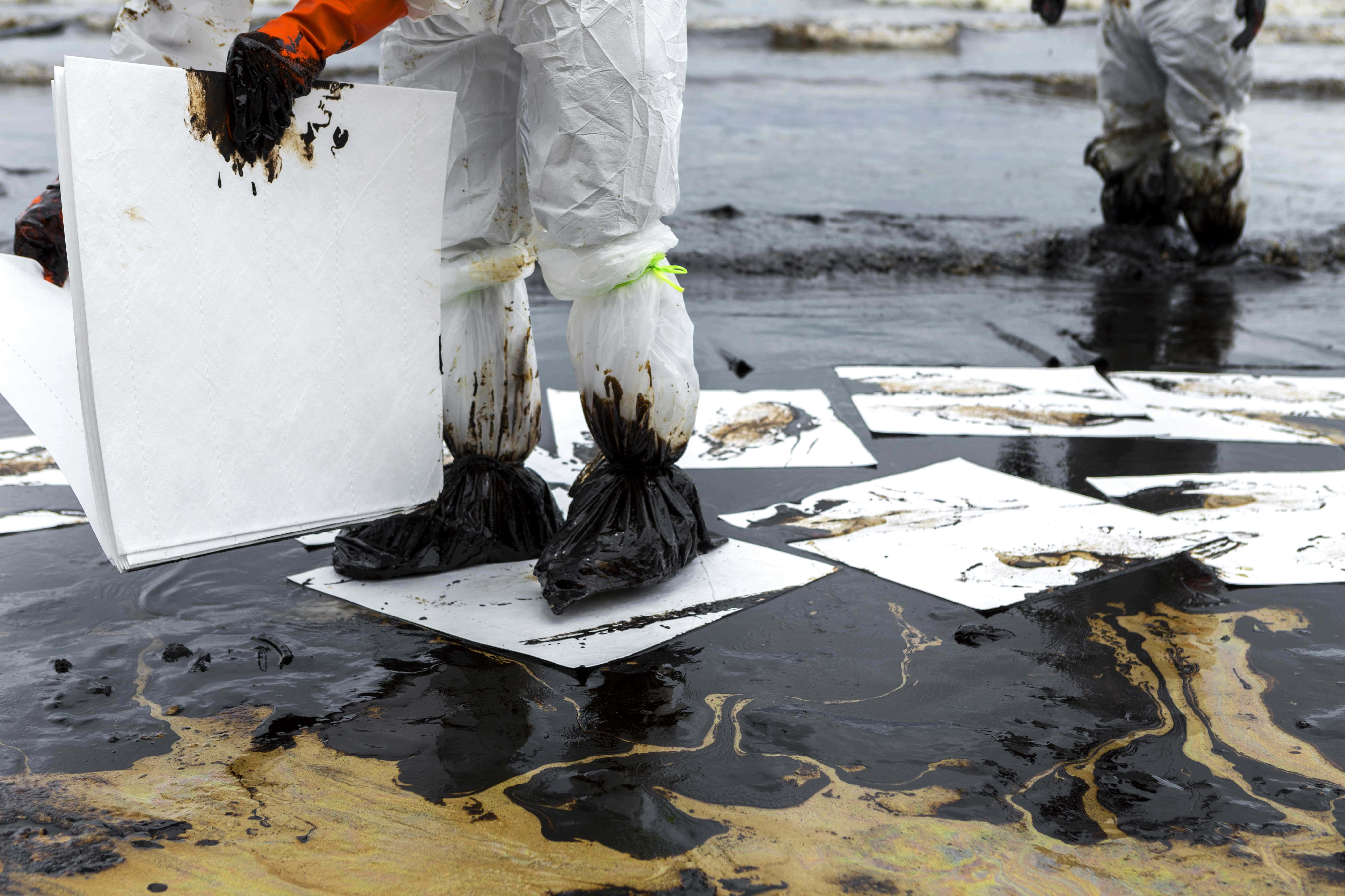 Oil spill cleanup by a technician